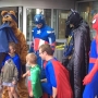 Superhero window washers assemble to make young hospital patients smile